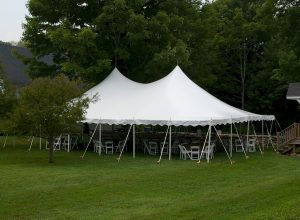 30'x45' Pole Tent with white party chairs