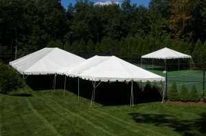 30'x60' Frame Tent with married 20'x30' Frame Tent and offset 20'x20' Frame Tent by tennis court