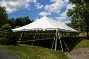 30x90 Pole Tent with stone wall Behind it