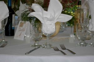 Simple Buffet Table Setting with Water Goblet, Wine Glass, and White Napkin set prior to a wedding