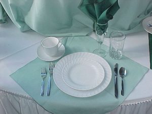 White china table setting with light blue cloths